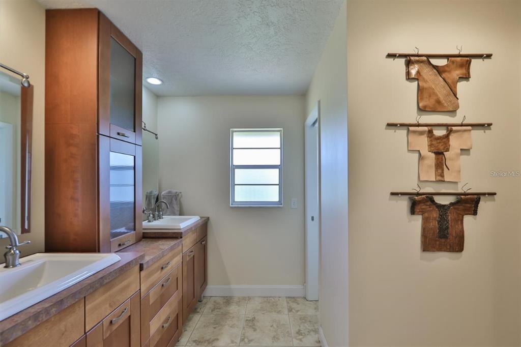 1820 El Rancho Drive Sun City Center, FL 33573 - Photo 30 of 70 a spacious bathroom with a sink and mirror