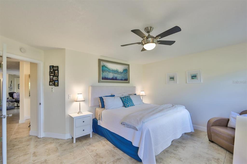 1820 El Rancho Drive Sun City Center, FL 33573 - Photo 32 of 70 a bedroom with a bed and a chandelier
