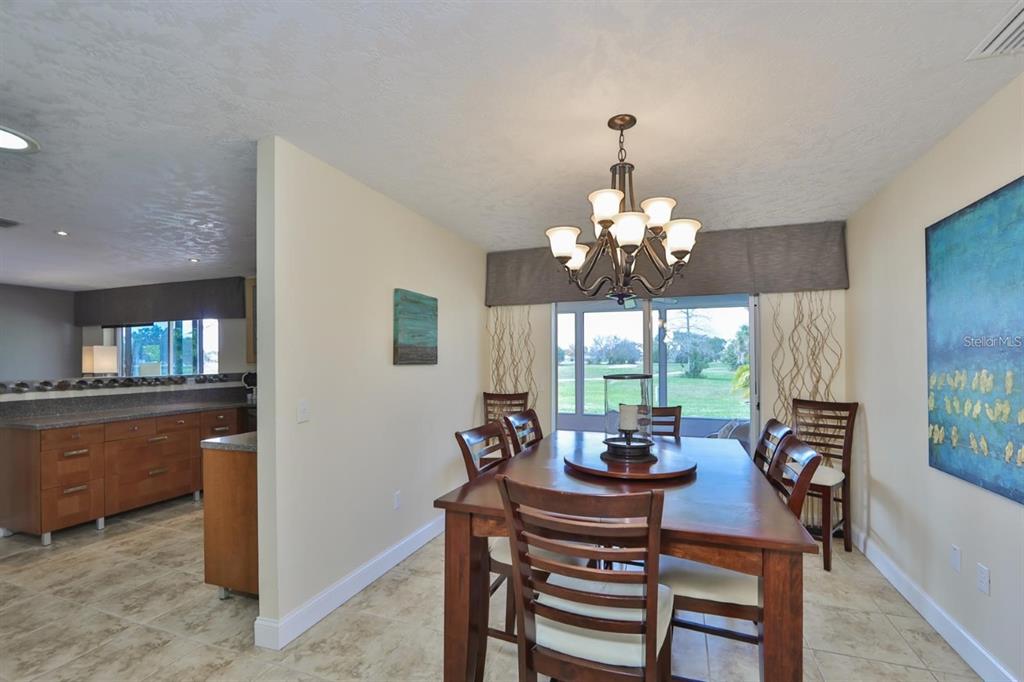1820 El Rancho Drive Sun City Center, FL 33573 - Photo 34 of 70 a dining room with furniture a chandelier and window