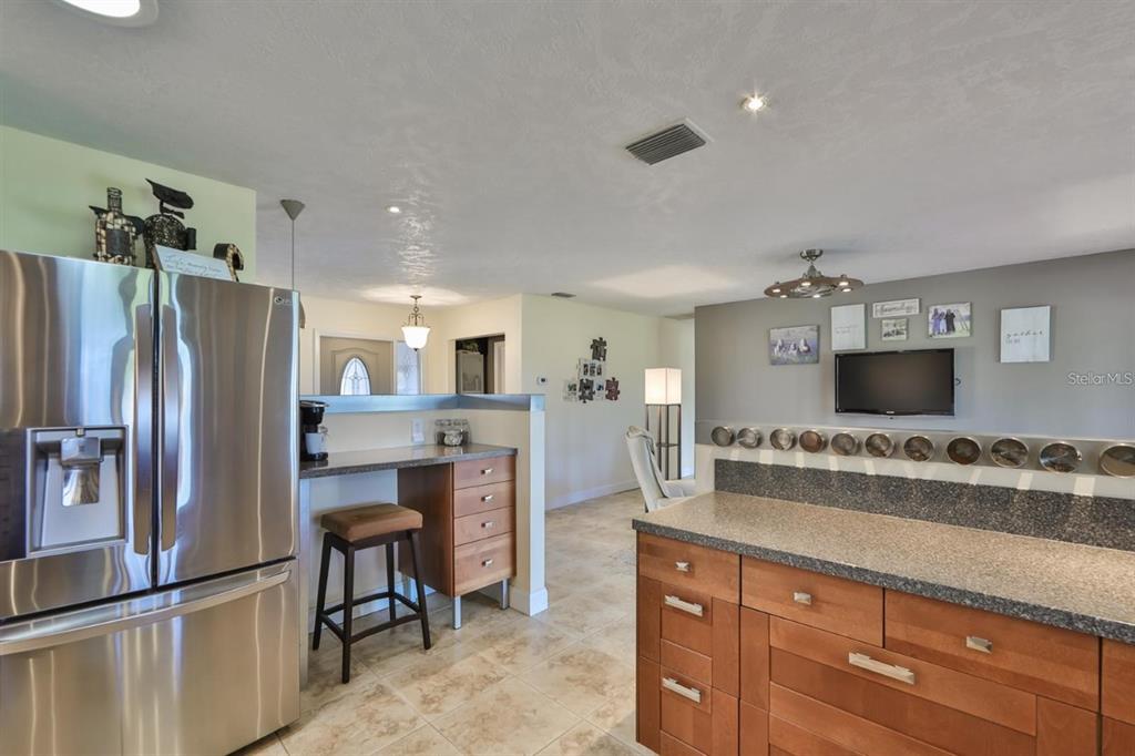 1820 El Rancho Drive Sun City Center, FL 33573 - Photo 37 of 70 a kitchen with refrigerator and cabinets