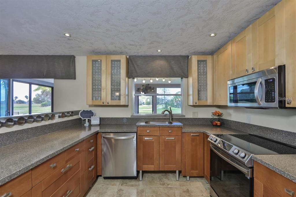 1820 El Rancho Drive Sun City Center, FL 33573 - Photo 38 of 70 a kitchen with a sink stove top oven and microwave