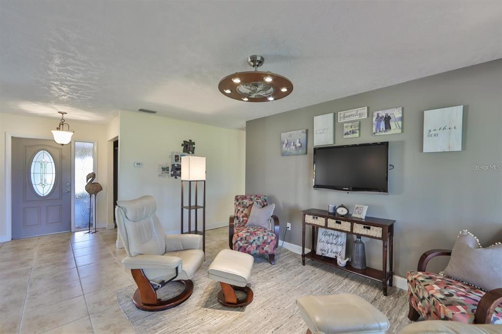 1820 El Rancho Drive Sun City Center, FL 33573 - Photo 41 of 70 a living room with furniture and a flat screen tv