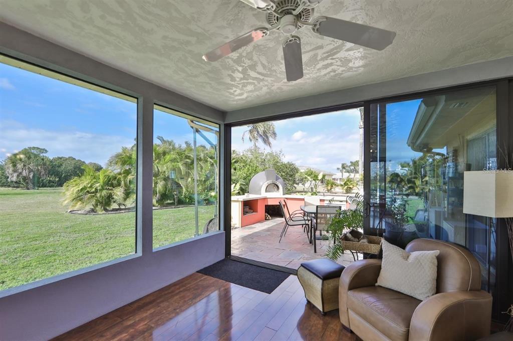 1820 El Rancho Drive Sun City Center, FL 33573 - Photo 49 of 70 a living room with furniture and a floor to ceiling window