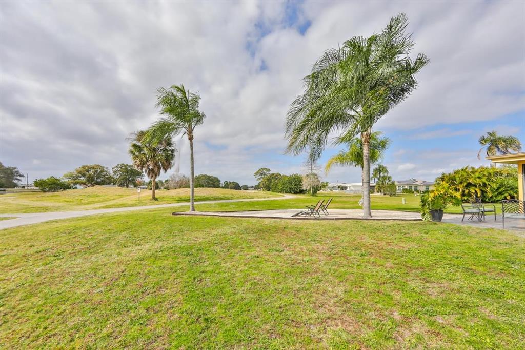 1820 El Rancho Drive Sun City Center, FL 33573 - Photo 56 of 70 a view of a swimming pool with an outdoor space and seating area