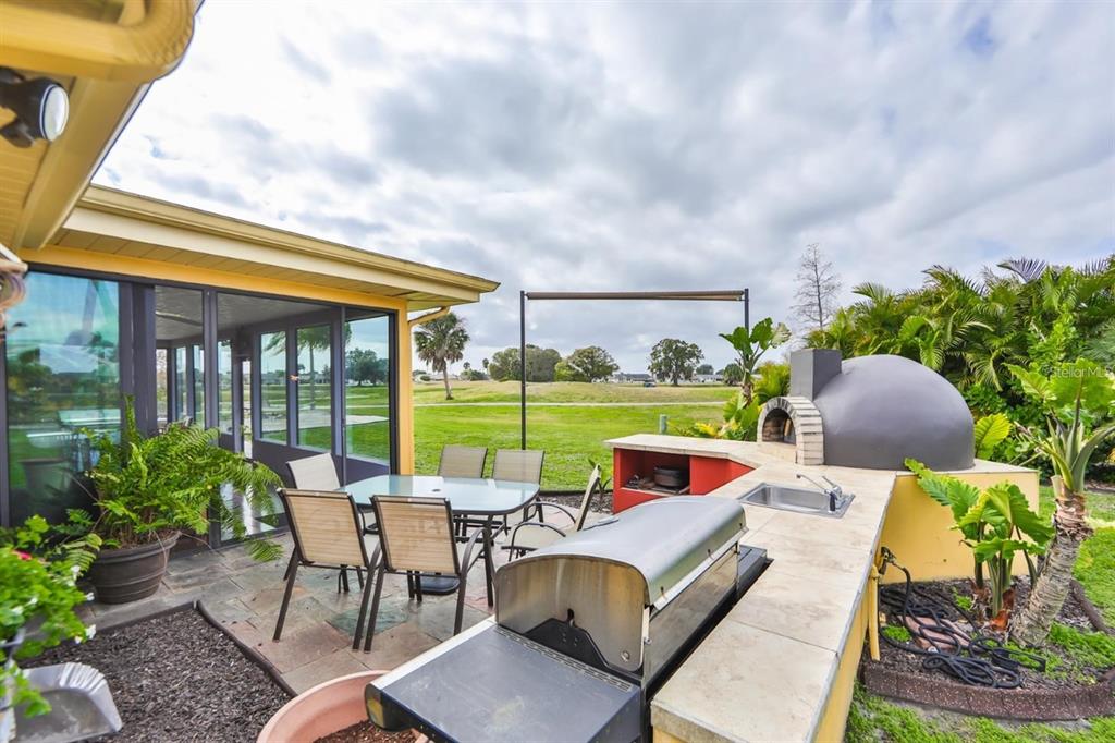 1820 El Rancho Drive Sun City Center, FL 33573 - Photo 60 of 70 a view of an outdoor sitting area with furniture and garden