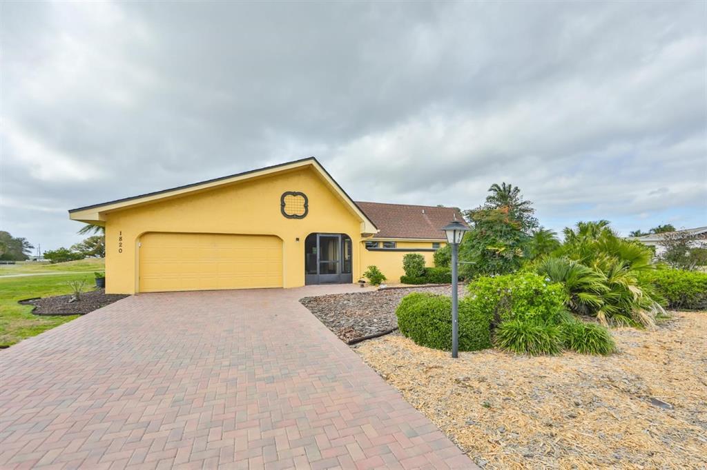 1820 El Rancho Drive Sun City Center, FL 33573 - Photo 65 of 70 a front view of a house with a yard and garage