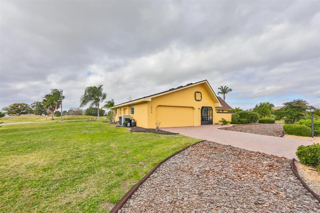 1820 El Rancho Drive Sun City Center, FL 33573 - Photo 68 of 70 a front view of a house with a yard and garage