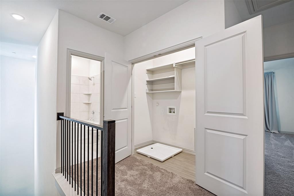 1006 Emil Place Allen, TX 75013 - Photo 14 of 28 Upper-level hallway featuring a built-in laundry closet with shelving and utility hookups
