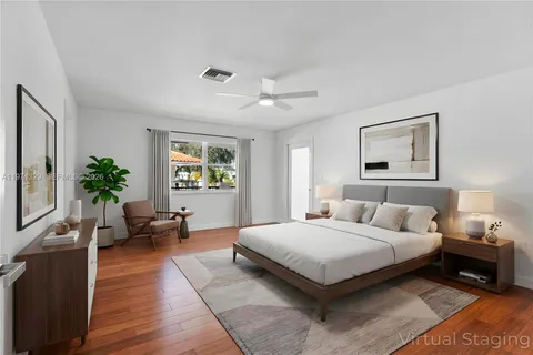 a bedroom with a large bed and potted plant