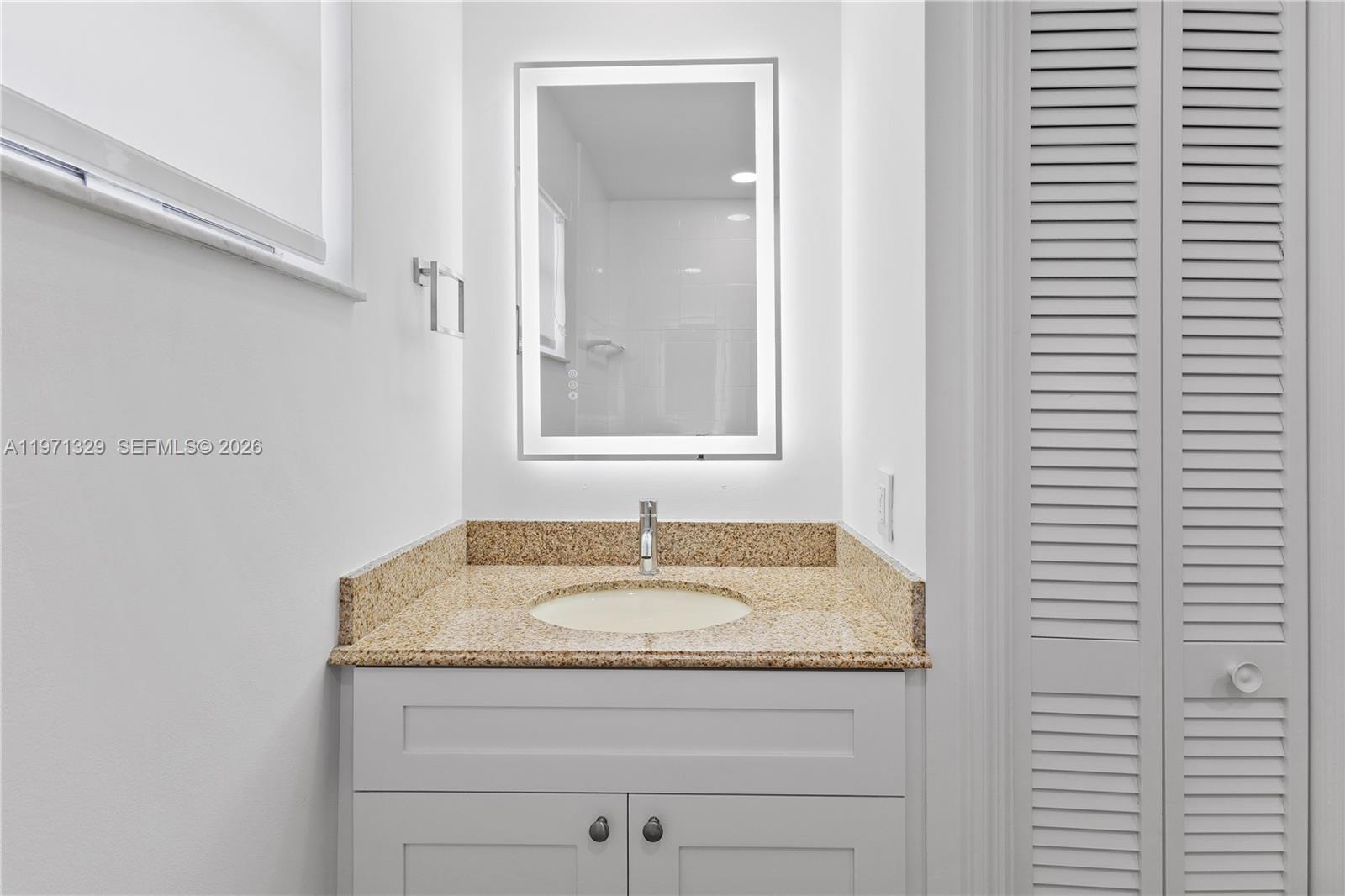 2870 Southwest 21st Street Miami, FL 33145 - Photo 19 of 34 a bathroom with a granite countertop sink and a mirror