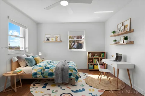a bedroom with furniture and a wooden floor