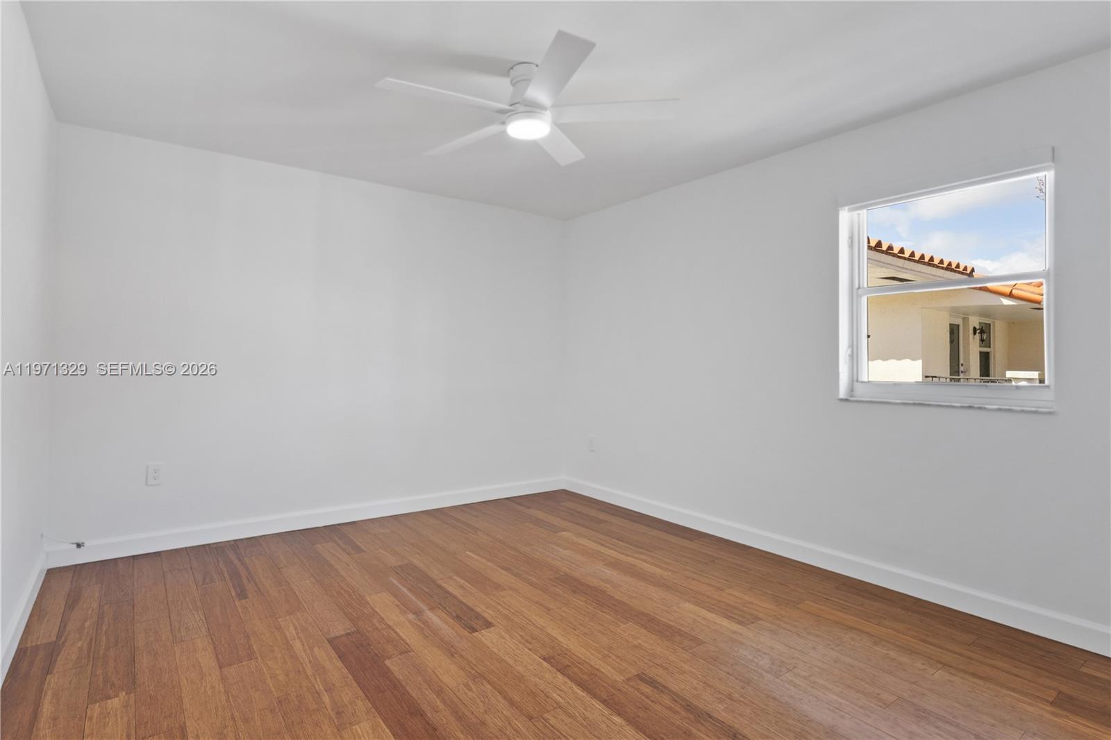 2870 Southwest 21st Street Miami, FL 33145 - Photo 24 of 34 a view of a room with wooden floor and a ceiling fan