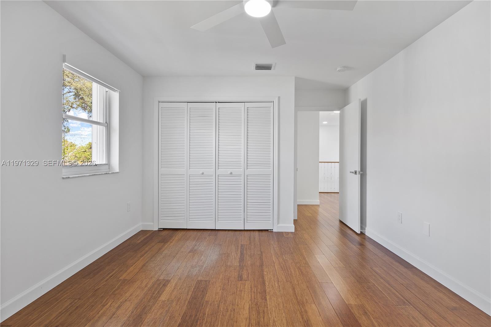 2870 Southwest 21st Street Miami, FL 33145 - Photo 25 of 34 a view of an empty room with wooden floor and a window