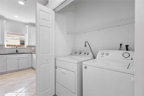 a view of storage and utility room with washer and dryer