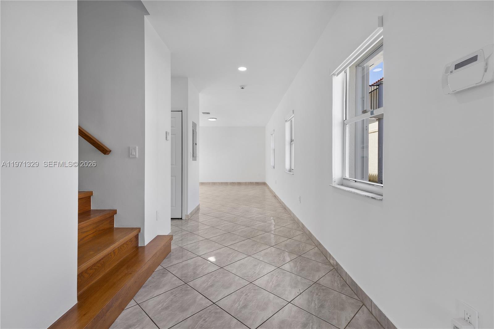 2870 Southwest 21st Street Miami, FL 33145 - Photo 7 of 34 a view of a hallway with wooden floor and staircase