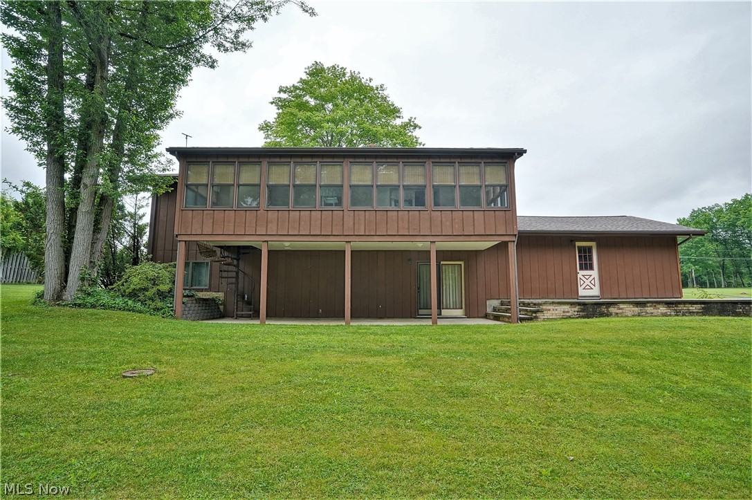 4261 Industry Road Rootstown, OH 44272 - Photo 20 of 25 Covered patio area. View of back sunroom. House features a full finished walk-out basement.