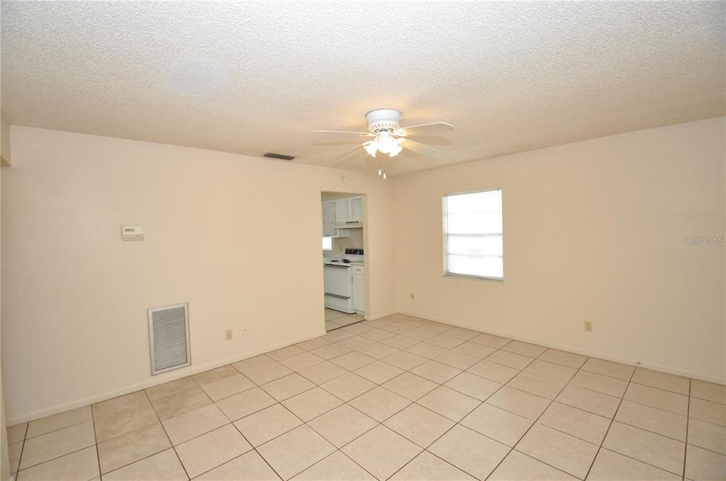 1434 East Fern Road, Unit 1434 Lakeland, FL 33801 - Photo 3 of 13 an empty room with chandelier fan