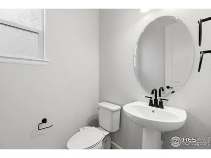 a bathroom with a sink a toilet and mirror