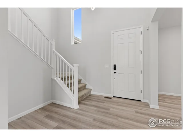 a view of an entryway with wooden floor