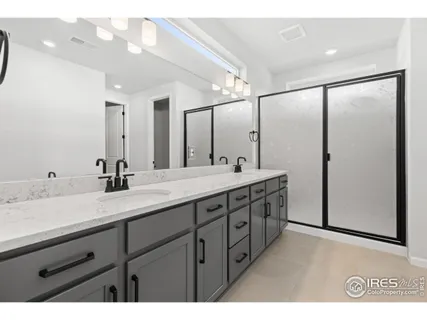 a bathroom with a double vanity sink and a mirror