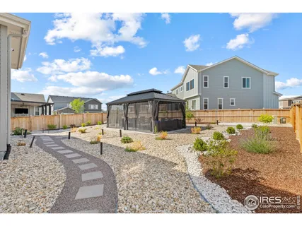 a swimming pool with outdoor seating and yard