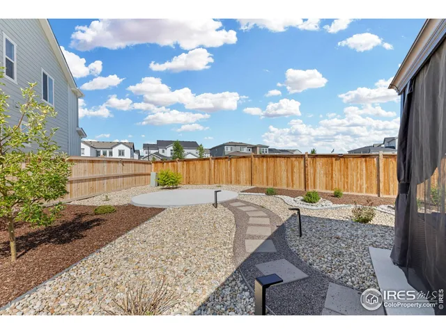a view of a backyard with sitting area