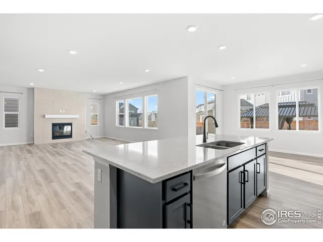 a kitchen with granite countertop a stove and a sink
