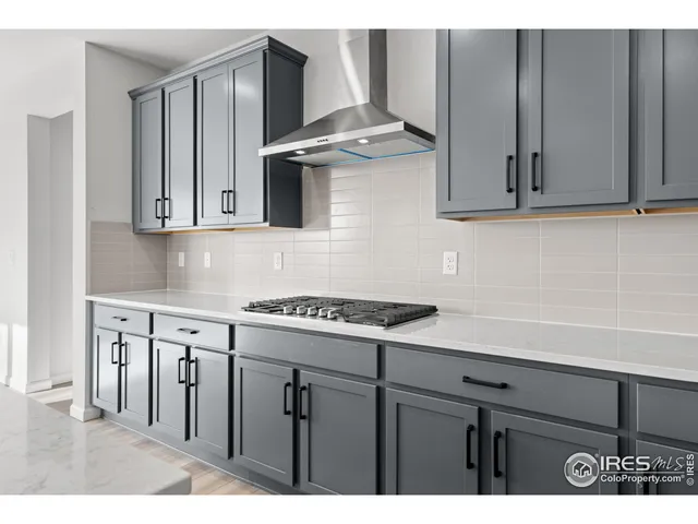 a kitchen with stainless steel appliances granite countertop a sink a stove and a microwave