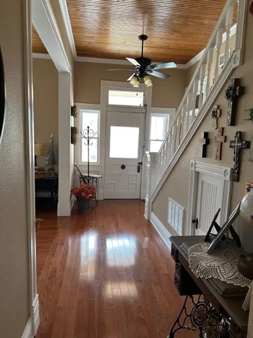 a view of entryway and hall with wooden floor