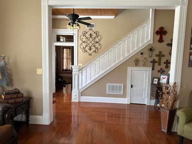 a view of entryway and hall with wooden floor