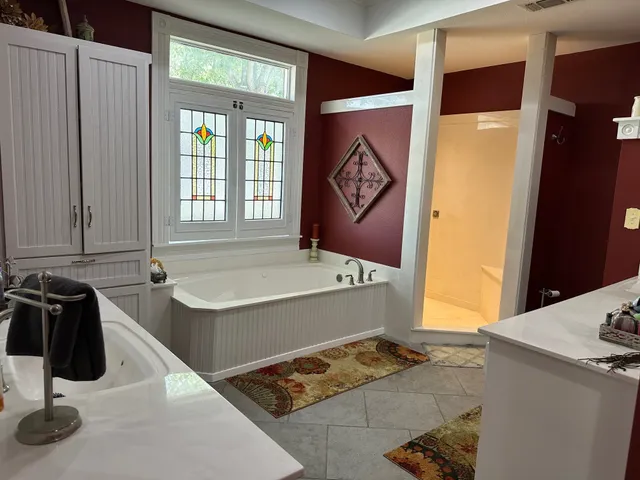 a bathroom with a tub and a window