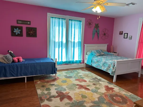 a bedroom with furniture and a window