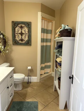 a bathroom with a toilet and a shower