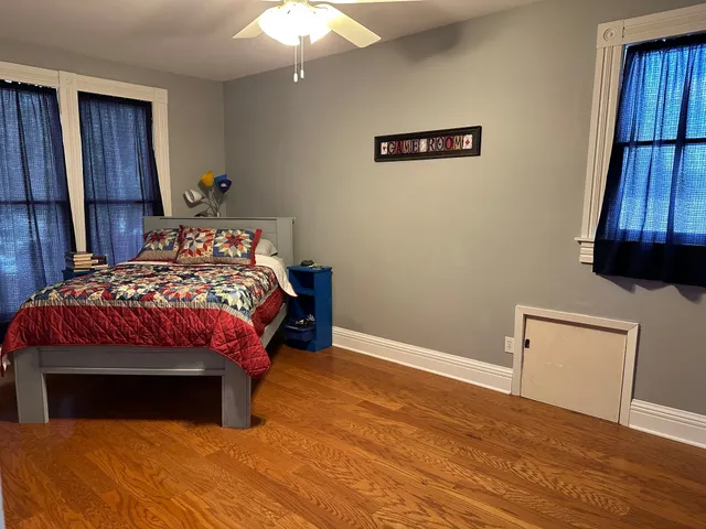 a bedroom with a bed and a television