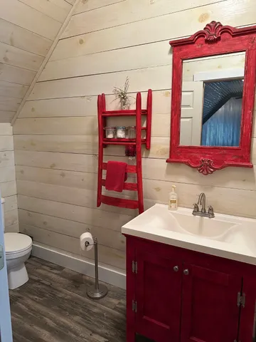 a bathroom with a sink toilet and mirror