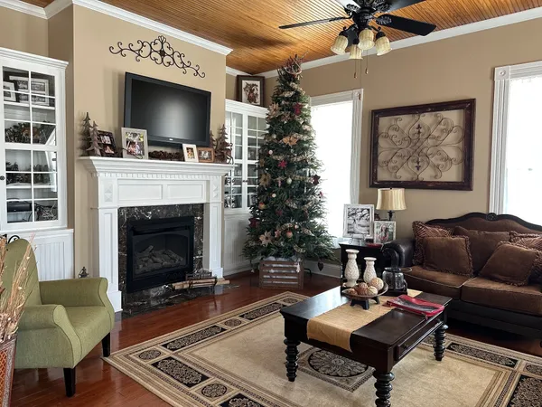 a living room with furniture a flat screen tv and a fireplace