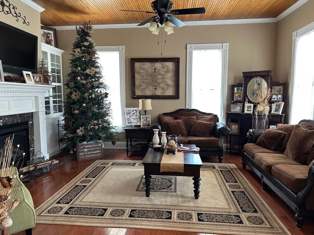 a living room with furniture a flat screen tv and a fireplace