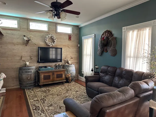 a living room with furniture and a flat screen tv