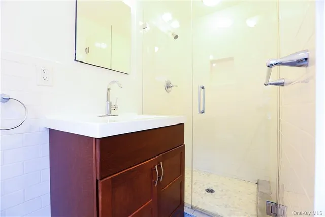 a bathroom with a sink vanity and a mirror