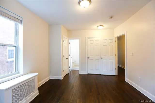 a view of a room with wooden floor and windows