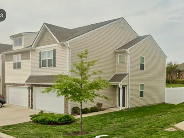 a view of a house with a yard and plants