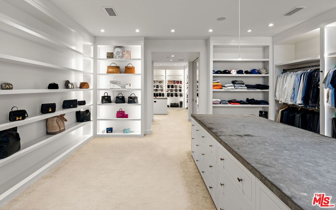 24848 Long Valley Road Hidden Hills, CA 91302 - Photo 11 of 38 a large white kitchen with stainless steel appliances kitchen island granite countertop a refrigerator and a sink