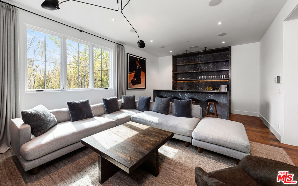 24848 Long Valley Road Hidden Hills, CA 91302 - Photo 16 of 38 a living room with furniture and a flat screen tv