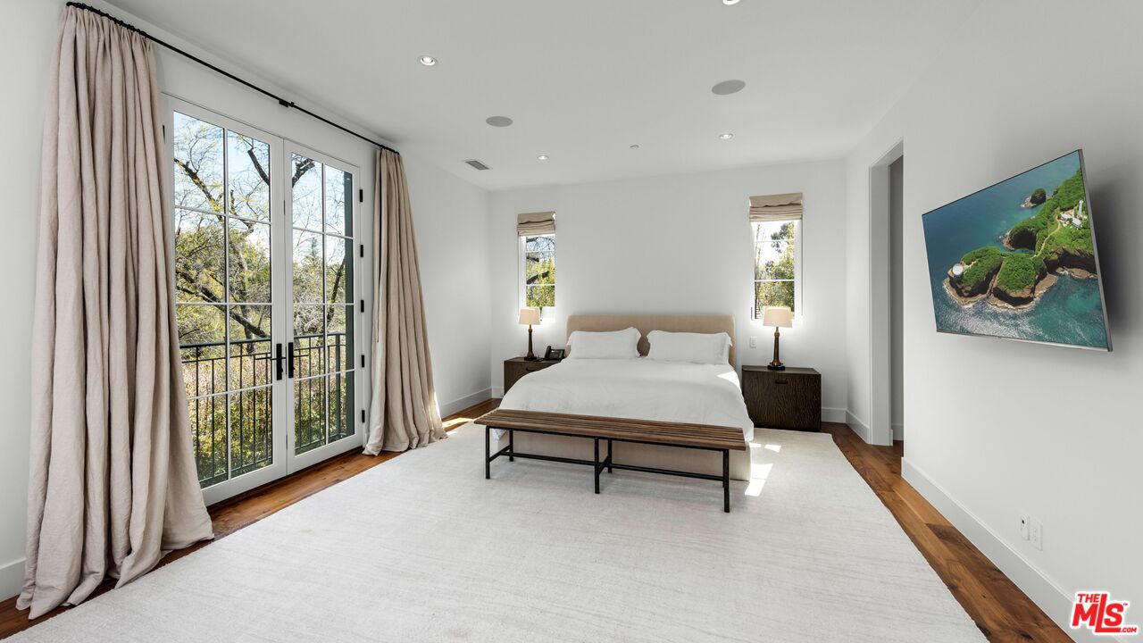 24848 Long Valley Road Hidden Hills, CA 91302 - Photo 17 of 38 a bedroom with furniture and a large window