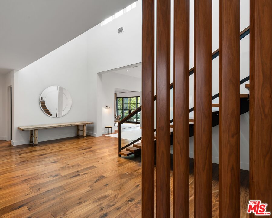24848 Long Valley Road Hidden Hills, CA 91302 - Photo 19 of 38 a view of a livingroom with wooden floor and furniture