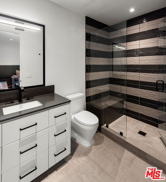 24848 Long Valley Road Hidden Hills, CA 91302 - Photo 23 of 38 a bathroom with a sink a toilet and shower