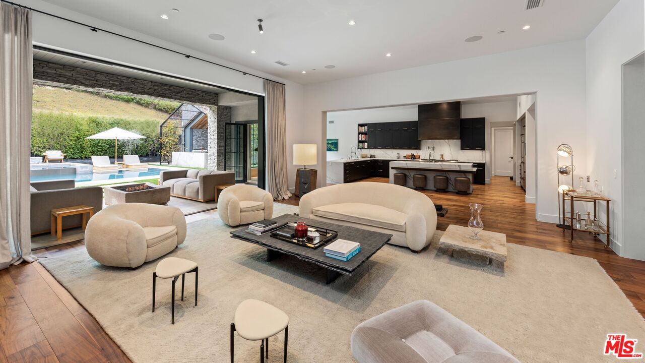 24848 Long Valley Road Hidden Hills, CA 91302 - Photo 3 of 38 a living room with furniture flat screen tv and a large window
