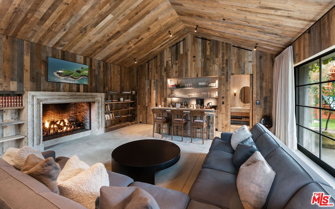 24848 Long Valley Road Hidden Hills, CA 91302 - Photo 35 of 38 a living room with furniture and a fireplace