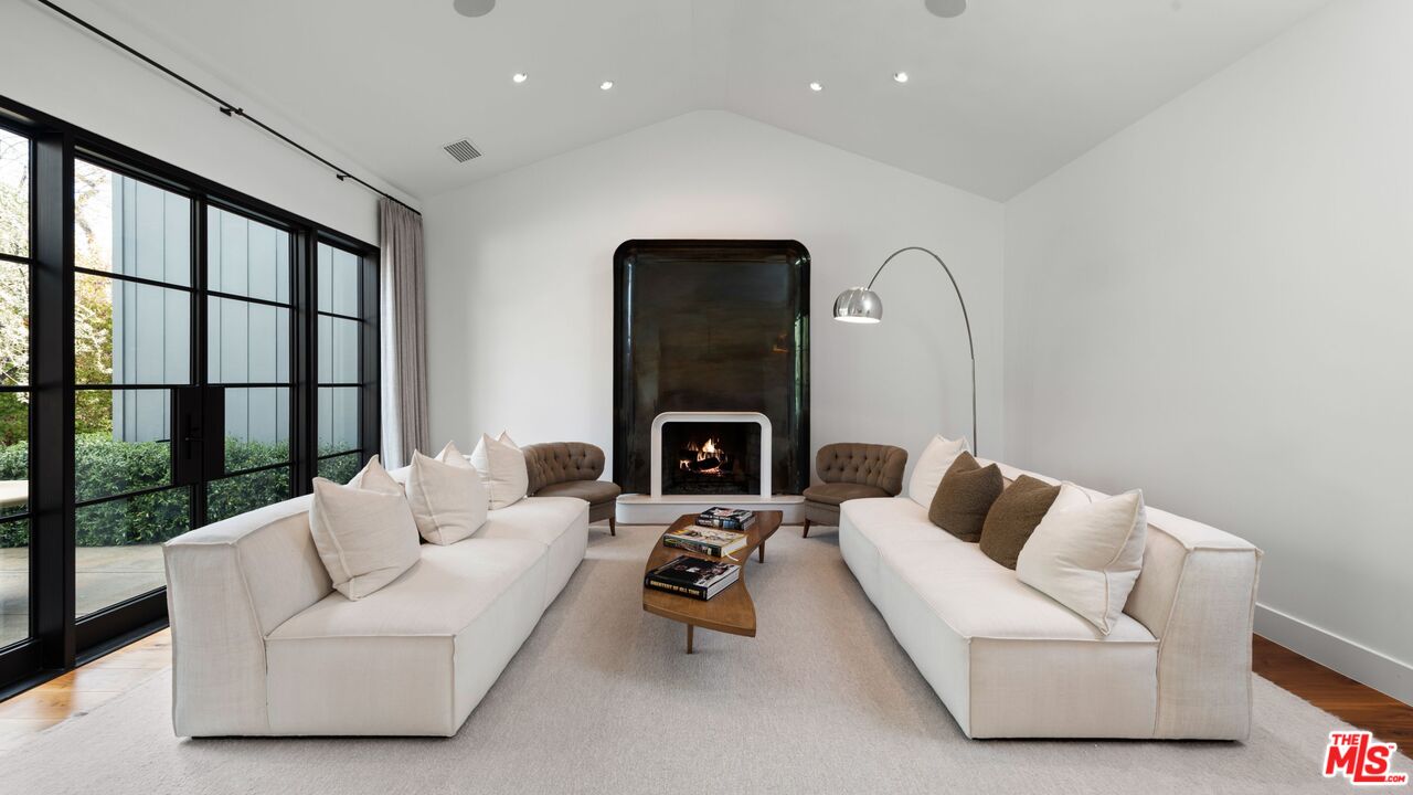 24848 Long Valley Road Hidden Hills, CA 91302 - Photo 5 of 38 a living room with furniture and a fireplace