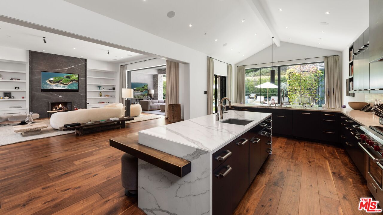 24848 Long Valley Road Hidden Hills, CA 91302 - Photo 7 of 38 a large kitchen with kitchen island a large counter top space a sink a window and stainless steel appliances